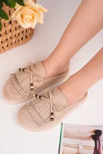 Mocassins Muggo FRINGE en daim, bout fermé, à pampilles et nœud décoratif.