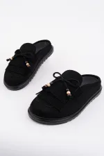 Mocassins Muggo FRINGE en daim, bout fermé, à pampilles et nœud décoratif.