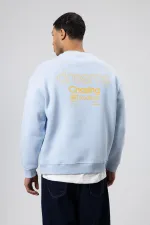 Sweat-shirt oversize à col rond imprimé bleu ciel