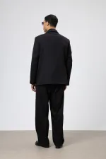 Costume noir oversize ceinturé