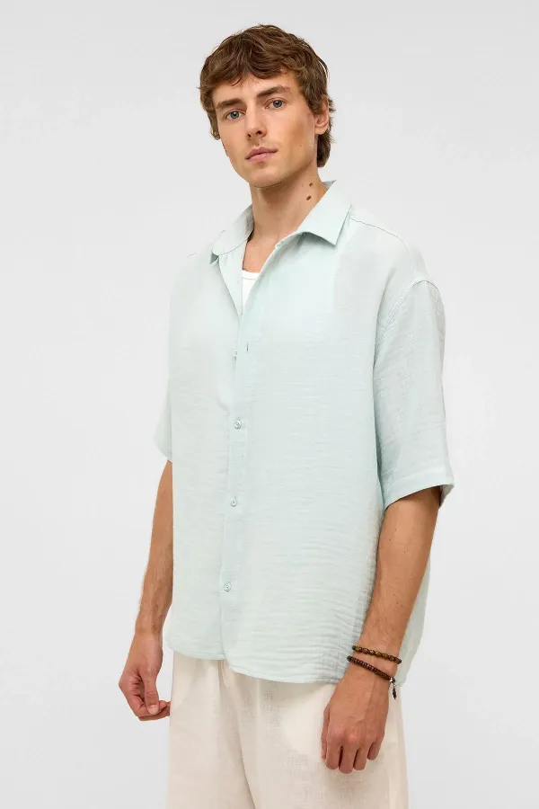 Chemise oversize à manches courtes en mousseline, bleue
