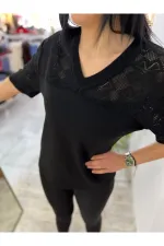 Off-white blouse with lettering and pearl details.