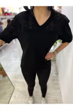 Off-white blouse with lettering and pearl details.