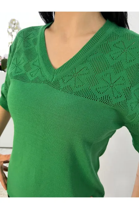 Off-white blouse with lettering and pearl details.