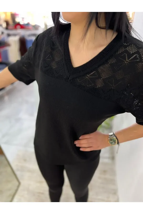 Off-white blouse with lettering and pearl details.