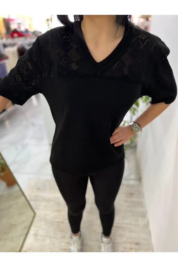 Off-white blouse with lettering and pearl details.