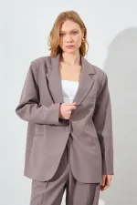 Blazer pour femme en vison à quatre boutons et poches passepoilées