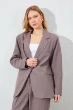Blazer pour femme en vison à quatre boutons et poches passepoilées