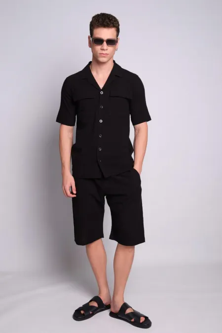 Chemise noire pour homme à col Apaj, manches courtes, poches à rabat et motif en relief