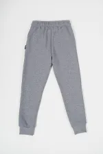 Pantalon de survêtement gris en coton épais avec taille et chevilles élastiques, pour filles de 5 à 12 ans.