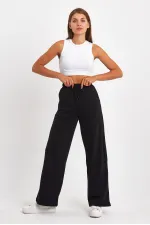 Pantalon de survêtement 4 pièces pour femme, coupe ample, poches latérales, coloris noir, bleu marine, anthracite et gris.