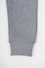 Pantalon de survêtement gris en coton épais avec taille et chevilles élastiques, pour filles de 5 à 12 ans.