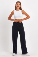 Pantalon de survêtement 4 pièces pour femme, coupe ample, poches latérales, coloris noir, bleu marine, anthracite et gris.