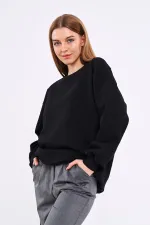 Sweat-shirt basique oversize en coton noir pour femme, col rond.