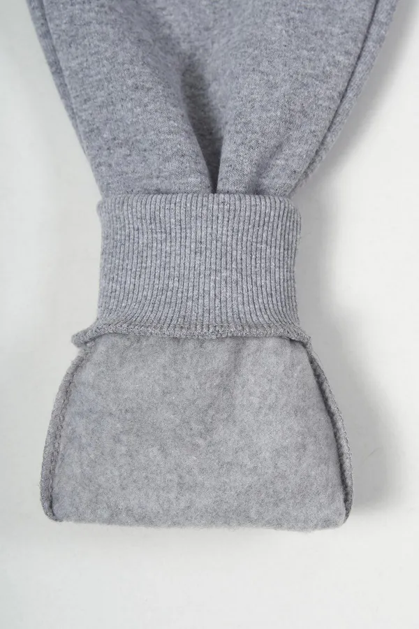 Pantalon de survêtement gris en coton épais avec taille et chevilles élastiques, pour filles de 5 à 12 ans.