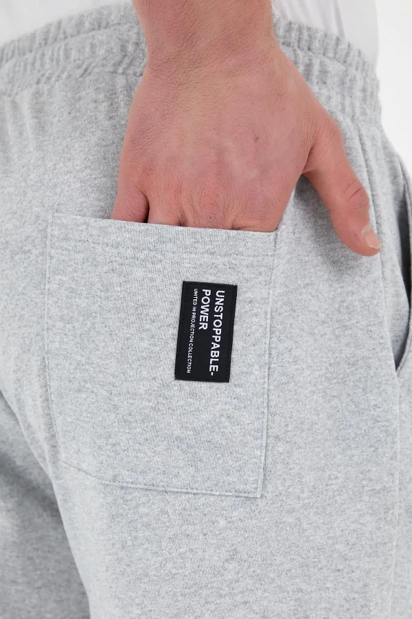 Pantalon de survêtement gris pour homme avec étiquette, poches arrière et latérales, coupe classique, taille élastique