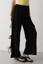 Pantalon noir 100 % coton avec fente latérale et détail de ceinture à nouer