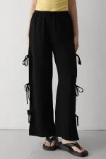 Pantalon noir 100 % coton avec fente latérale et détail de ceinture à nouer