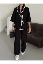 Ensemble chemisier et pantalon noir à bordures naturelles