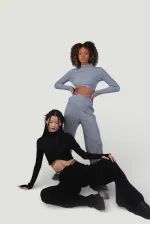 Pantalon en maille stretch noir à taille élastique et jambes larges