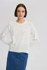 PULL EN MAILLE À PAILLETTES