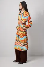 ABSTRACT PATTERNED TRENCH COAT WITH GATHERED WAIST.
