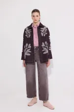 VESTE EN JEAN AVEC BRODERIE APPLIQUE ET CEINTURE.