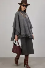 PONCHO EN MAILLE À FRANGES
