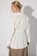 PEPLUM TUNIC WITH CORSET AT THE WAIST