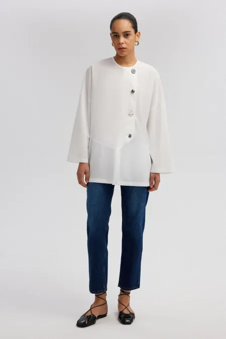 ASYMMETRICAL CUT SHIRT WITH BUTTON DETAIL