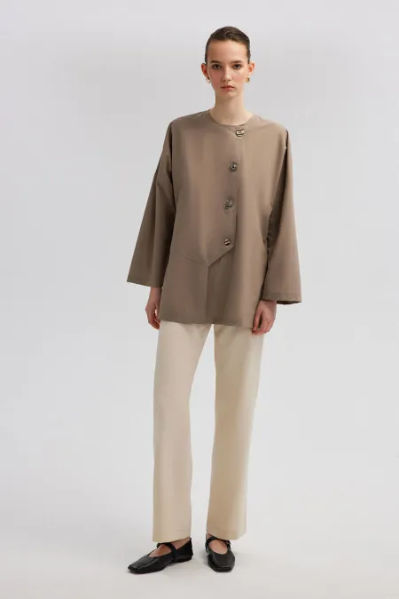 ASYMMETRICAL CUT SHIRT WITH BUTTON DETAIL