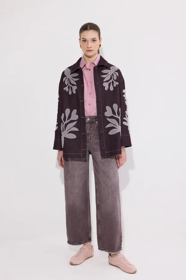 VESTE EN JEAN AVEC BRODERIE APPLIQUE ET CEINTURE.