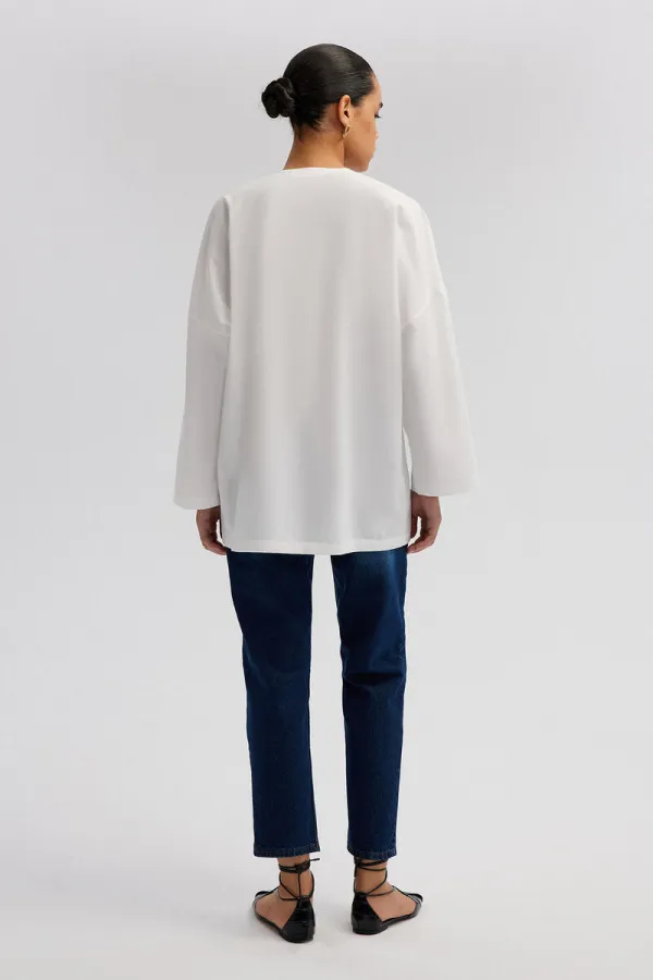 ASYMMETRICAL CUT SHIRT WITH BUTTON DETAIL ASYMMETRICAL CUT SHIRT WITH BUTTON DETAIL