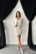 Ensemble veste et pantalon garnis de cuir triple écru en gros