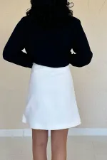 Mini-jupe fendue écrue à détails roses en gros