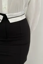 Mini-jupe noire ceinturée en gros