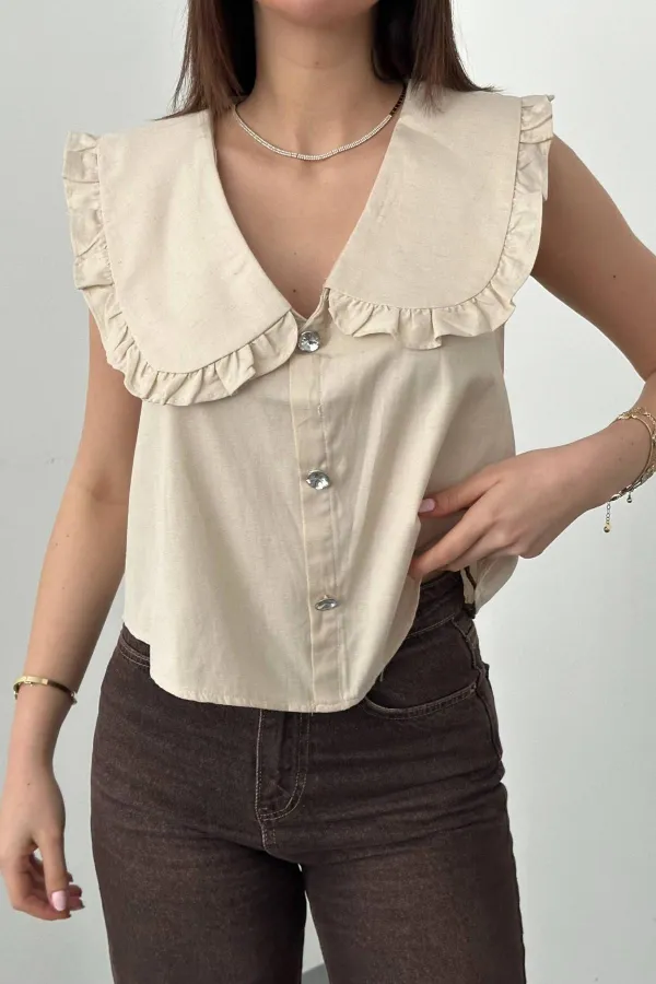 Blouse beige à boutons sur le devant et col bébé, vendue en gros