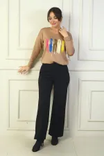 Pantalon en acier à jambes larges pour femme, avec taille élastique, poches latérales et finitions.