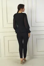 Two-piece set with chiffon sleeves and beaded shoulders.