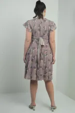 Wrap-neck, ruffled sleeve, lined plus-size printed linen dress.