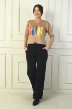 Pantalon en acier à jambes larges pour femme, avec taille élastique, poches latérales et finitions.