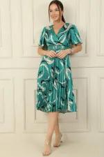 Wrap-neck, slit, ruffled sleeve, patterned, belted, pleated, lined satin dress.