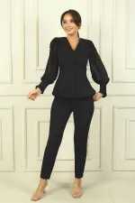 Two-piece set with chiffon sleeves and beaded shoulders.