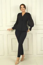 Two-piece set with chiffon sleeves and beaded shoulders.