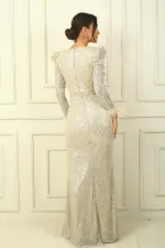 Wrap-neck, draped front, lined, feathered sleeves, sequined long dress.