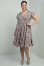 Wrap-neck, ruffled sleeve, lined plus-size printed linen dress.