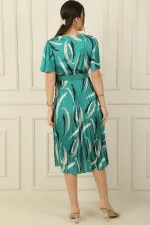 Wrap-neck, slit, ruffled sleeve, patterned, belted, pleated, lined satin dress.