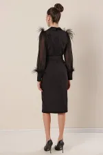Wrap-neck, belted waist, front slit, chiffon sleeves with cuffs and feather detail, crepe dress.