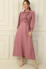 Long dress with half-button front, ribbed detail, and belted waist.