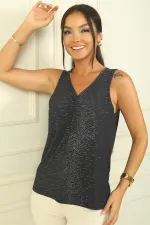 Blouse à col en V froncée sur le devant en lycra pailleté